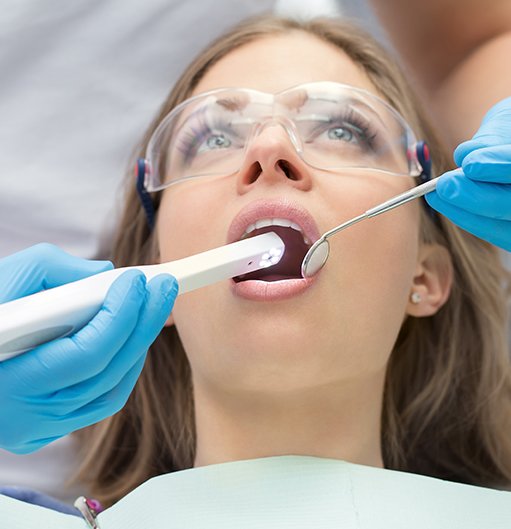 Dentist using intraoral camera to capture images of a patient's smile