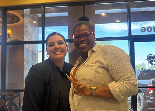 Dental team member and patient smiling together