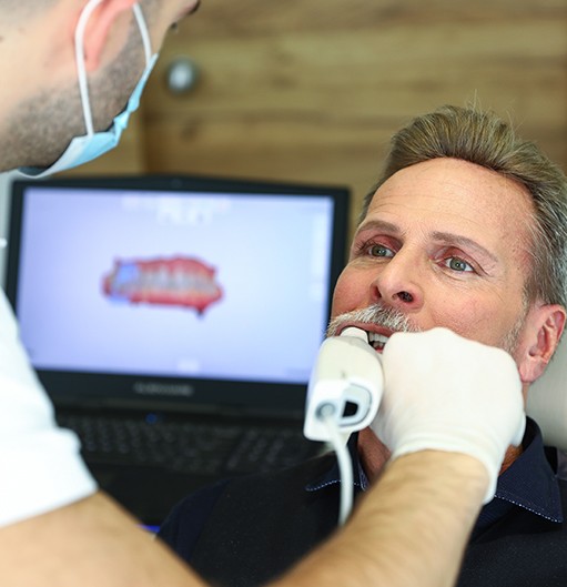 Dentist capturing digital impressions of a patient's smile