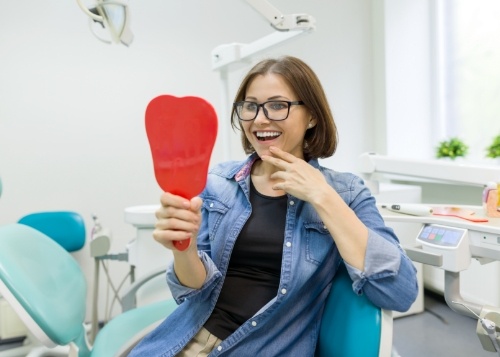 young woman smiling after getting dental crown in Goodyear