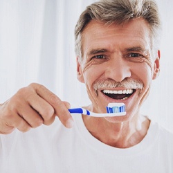 Man brushing his teeth to prevent dental emergency in Goodyear