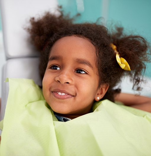 Little girl smiling during first dental visit