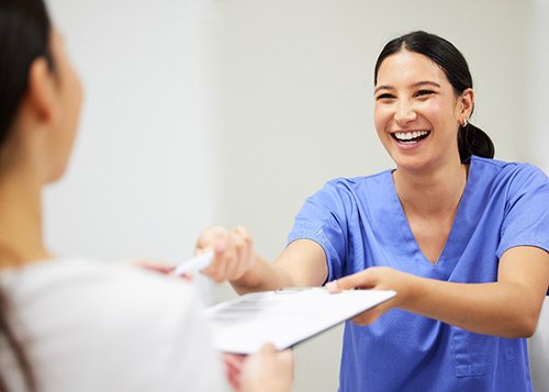 A woman paying for a smile makeover