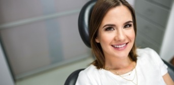 Woman in dental chair smiling during preventive dentistry visit