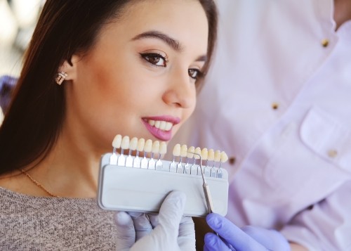 row of veneers being placed on several teeth