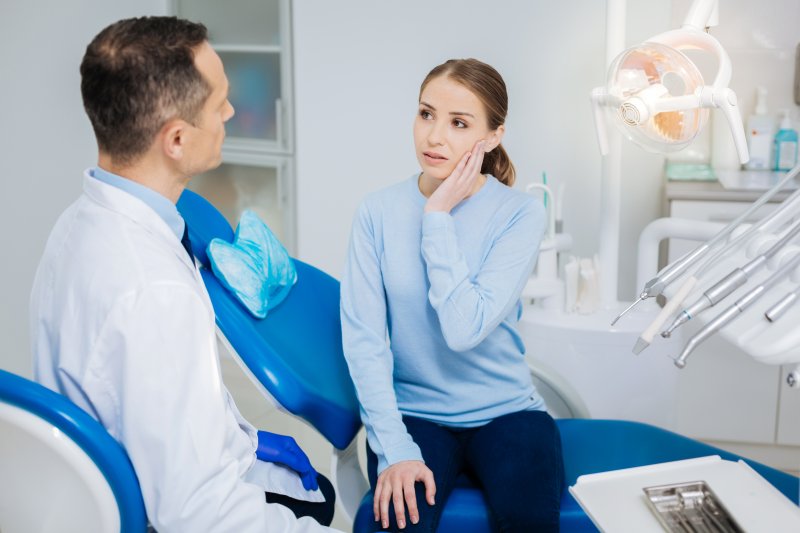 Dentist telling a patient she needs a root canal