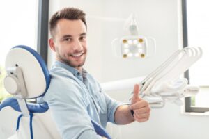 Man giving thumbs up after getting his fallen veneer fixed